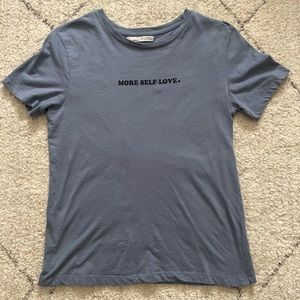 Graphic blue shirt. “love yourself”